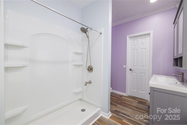 2005 Douglas Rd, Lancaster, SC 28720 - bathroom featuring a shower stall, vanity, crown molding, and wood finished floors