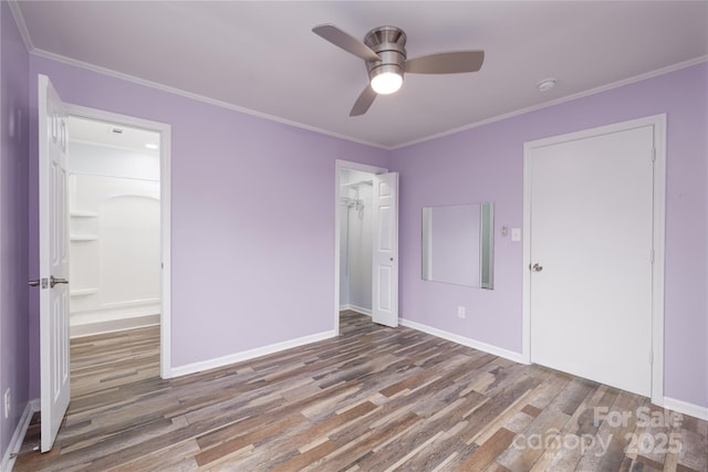 2005 Douglas Rd, Lancaster, SC 28720 - unfurnished bedroom featuring a closet, wood finished floors, baseboards, and ornamental molding