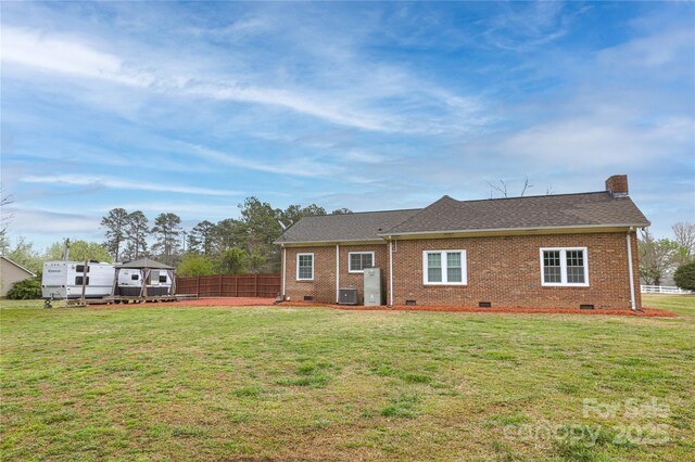 2005 Douglas Rd, Lancaster, SC 28720 - rear view of property with brick siding, roof with shingles, a fenced backyard, a yard, and crawl space