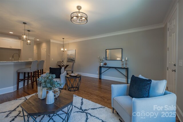 living area with crown molding, baseboards, and dark wood-style flooring