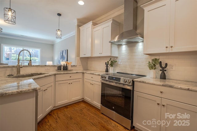 kitchen with tasteful backsplash, crown molding, wall chimney range hood, stainless steel range with electric stovetop, and a sink