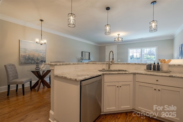 kitchen featuring dishwasher, wood finished floors, crown molding, and a sink