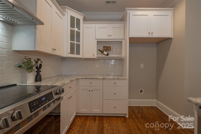 kitchen featuring electric stove, light stone counters, dark wood-style floors, range hood, and white cabinets