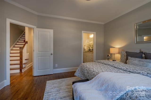 bedroom featuring baseboards, ensuite bath, dark wood-style floors, and crown molding