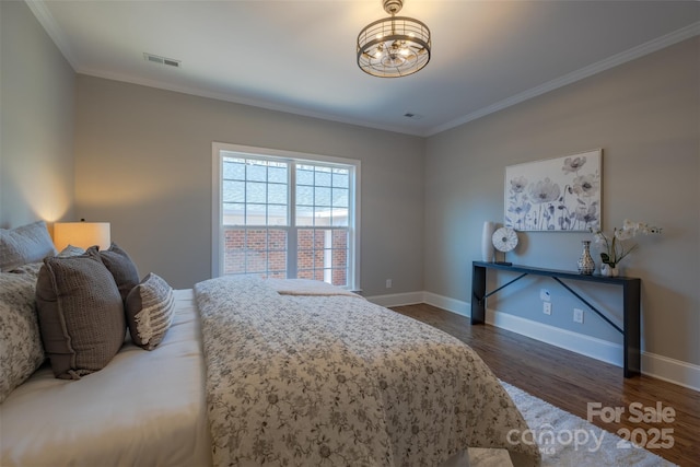 bedroom with visible vents, ornamental molding, baseboards, and dark wood-style flooring