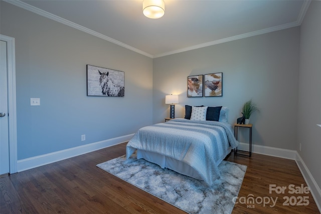 bedroom featuring ornamental molding, baseboards, and wood finished floors