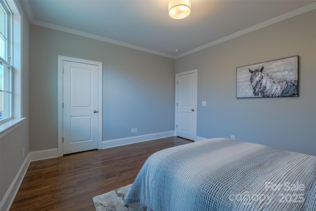 bedroom featuring baseboards, dark wood-style floors, and ornamental molding