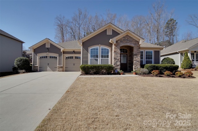 view of front facade with stone siding, driveway, and a garage