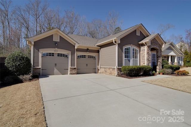 view of front facade featuring concrete driveway, a garage, and stone siding