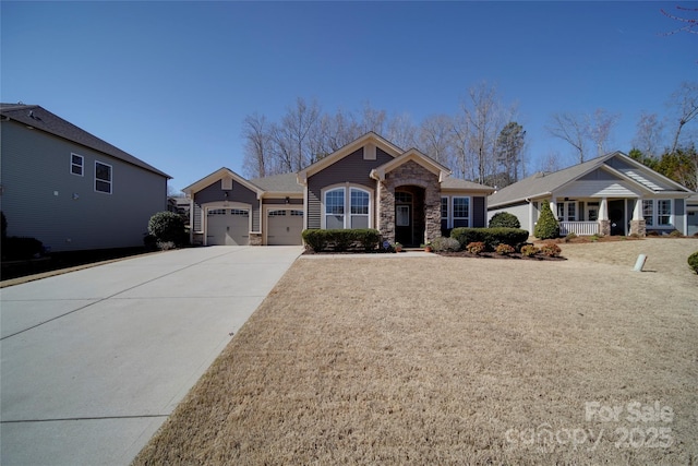 view of front of house with a garage, stone siding, and driveway