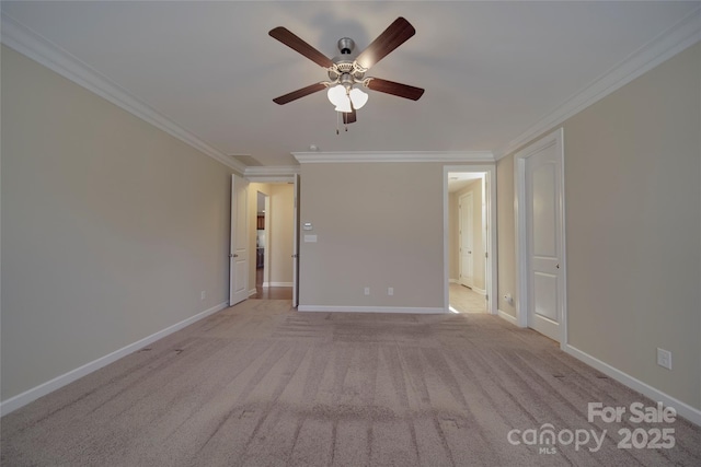 spare room featuring ornamental molding, a ceiling fan, baseboards, and light carpet