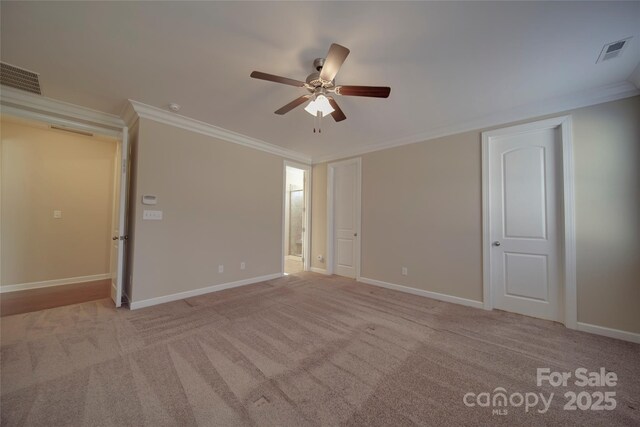 empty room with light carpet, baseboards, visible vents, and ornamental molding