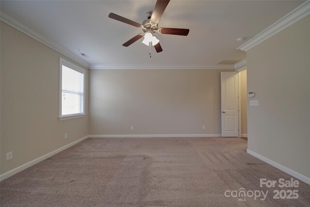 unfurnished room featuring light carpet, visible vents, crown molding, and baseboards