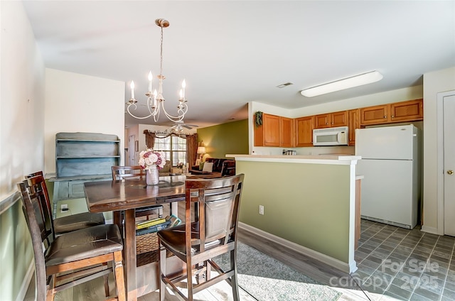 dining room with a chandelier and visible vents