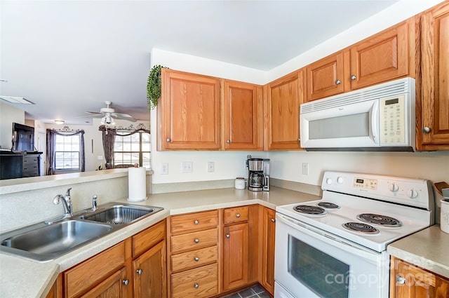 kitchen with white appliances, light countertops, visible vents, and a sink