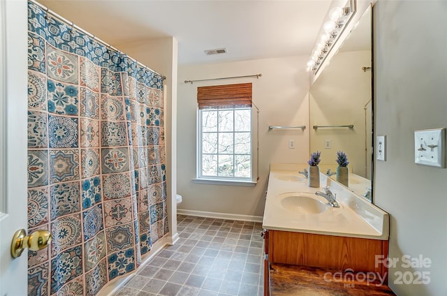 full bathroom featuring visible vents, toilet, baseboards, and a sink