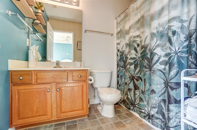 bathroom featuring vanity, tile patterned floors, curtained shower, and toilet