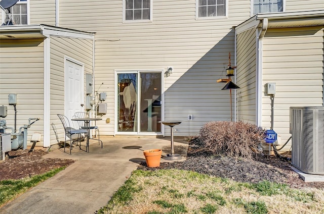 doorway to property with a patio area and central AC