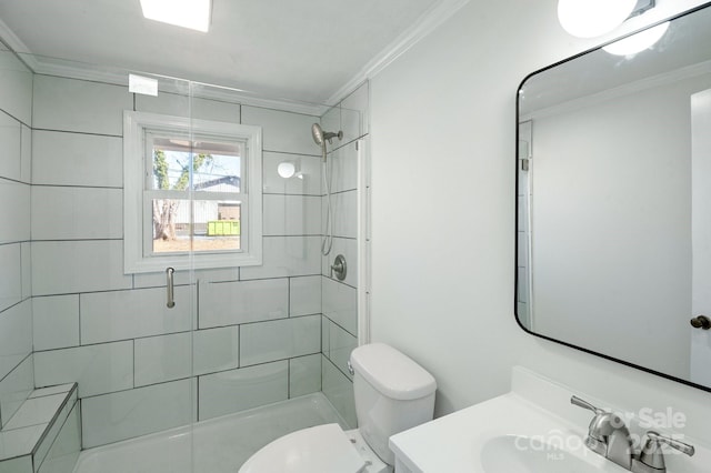 full bathroom featuring a shower stall, vanity, toilet, and crown molding