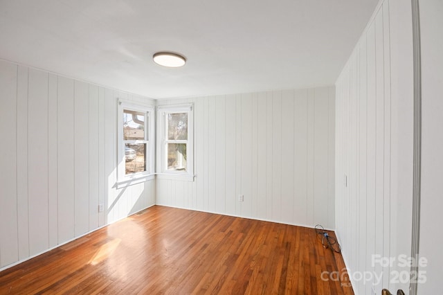 spare room featuring wood finished floors