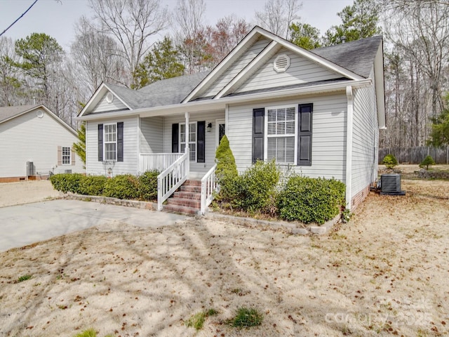 ranch-style home with a porch and central AC