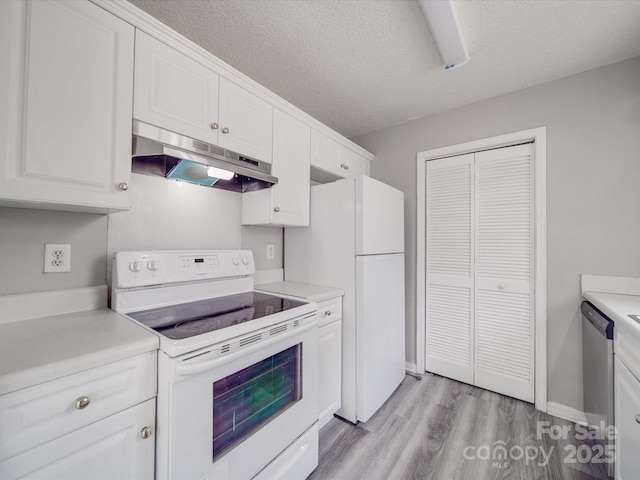 kitchen with under cabinet range hood, white cabinets, white appliances, and light countertops