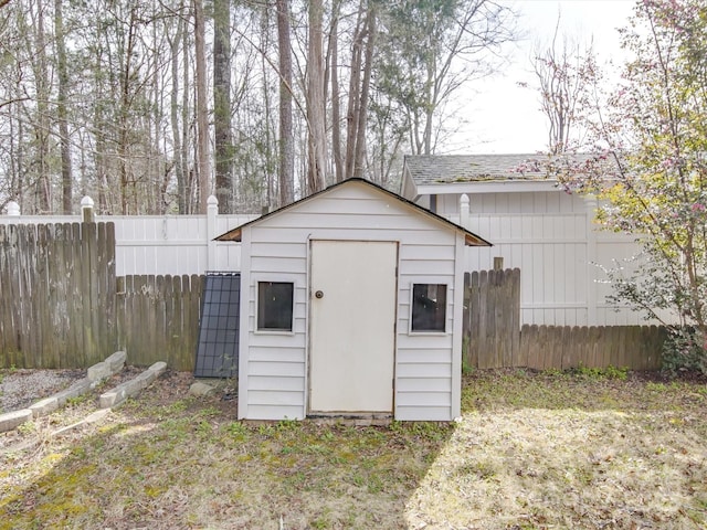 view of shed featuring fence