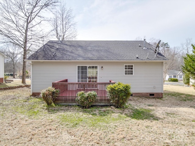 rear view of property with crawl space, a wooden deck, and a shingled roof