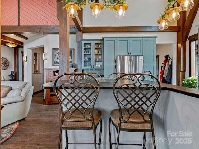 dining room with dark wood-style floors and beamed ceiling