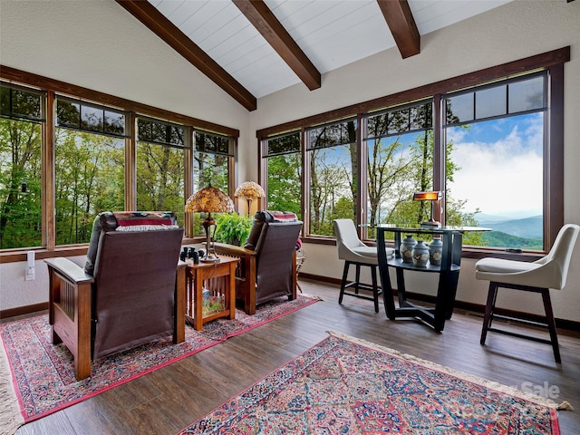 sunroom featuring a healthy amount of sunlight and lofted ceiling with beams