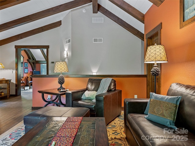 living room with lofted ceiling with beams and visible vents