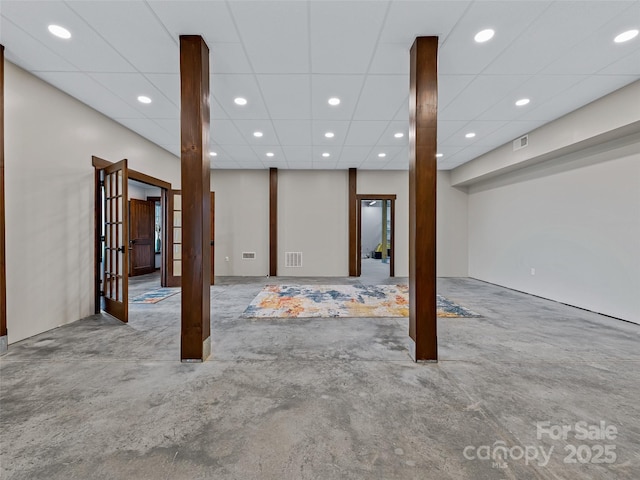 finished basement with recessed lighting, visible vents, and a paneled ceiling