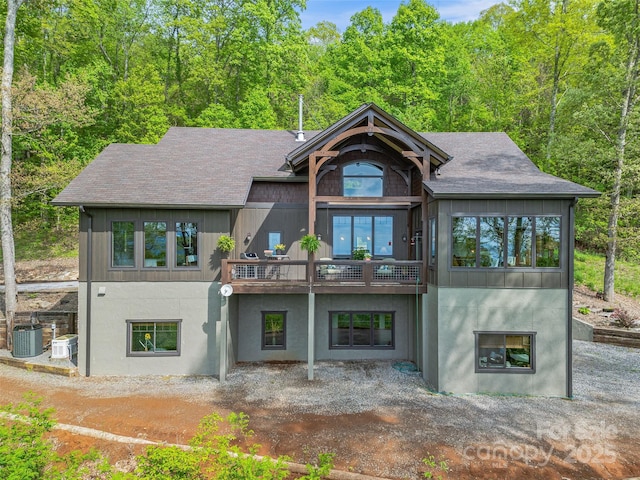 back of property featuring central air condition unit, stucco siding, and a shingled roof