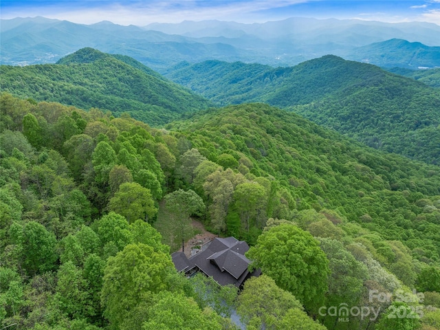 bird's eye view with a wooded view and a mountain view