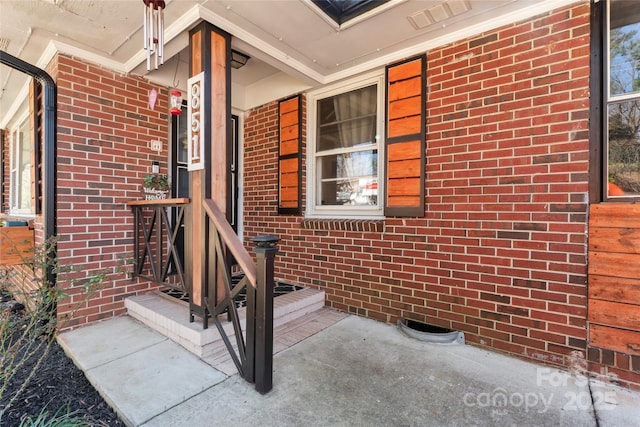 entrance to property with brick siding