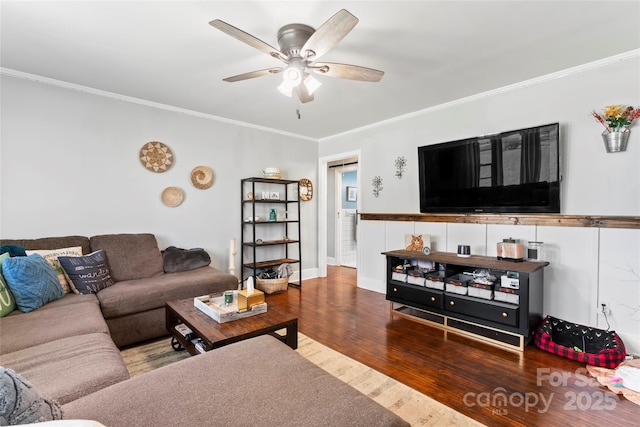 living area with ceiling fan, wood finished floors, and ornamental molding