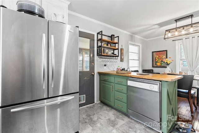 kitchen with dishwashing machine, green cabinetry, freestanding refrigerator, ornamental molding, and butcher block countertops