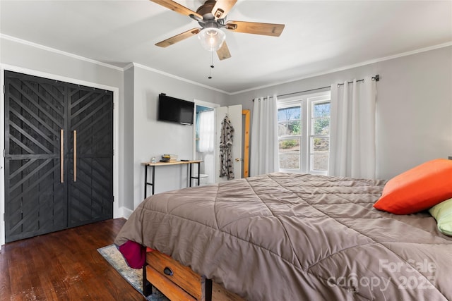 bedroom featuring a ceiling fan, crown molding, wood finished floors, and baseboards