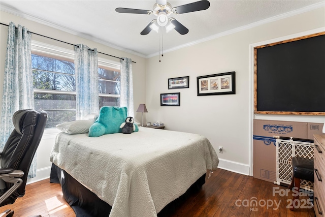 bedroom with ceiling fan, baseboards, wood finished floors, and crown molding