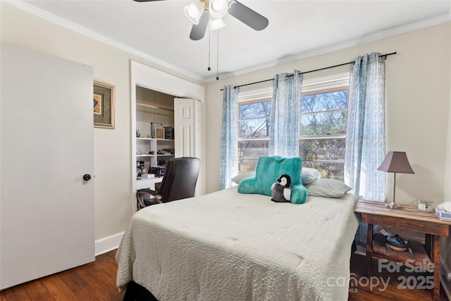 bedroom featuring a closet, baseboards, dark wood finished floors, and ornamental molding