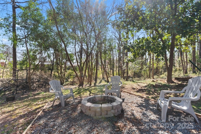 view of yard with an outdoor fire pit