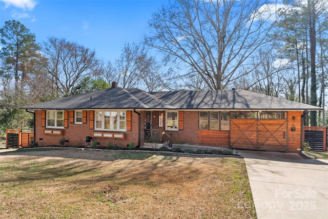 ranch-style home featuring crawl space, concrete driveway, a front lawn, and brick siding