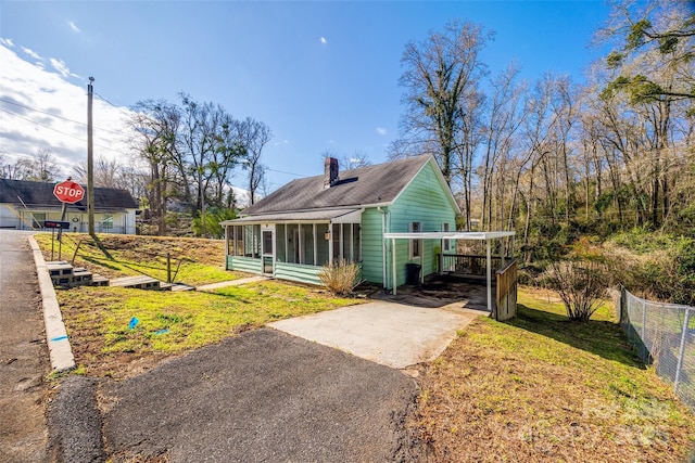 36 Brookline St, Great Falls, SC 29055 - exterior space featuring a front yard, fence, a sunroom, a chimney, and concrete driveway