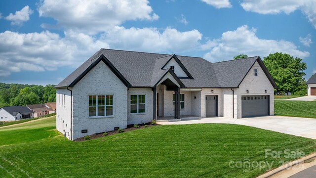 4227 Holly Cir NE, Conover, NC 28613 - view of front facade featuring brick siding, a garage, a front yard, and concrete driveway