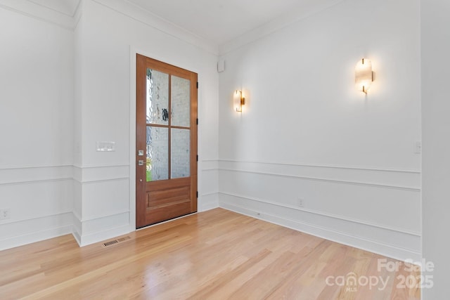 4227 Holly Cir NE, Conover, NC 28613 - entryway with crown molding, light wood-style flooring, and visible vents