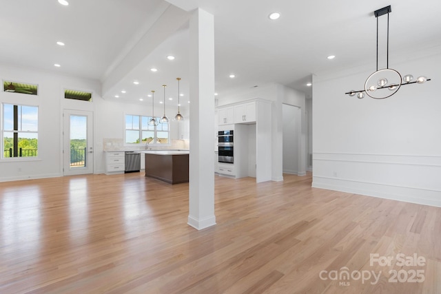 4227 Holly Cir NE, Conover, NC 28613 - unfurnished living room featuring baseboards, light wood-type flooring, recessed lighting, and a chandelier