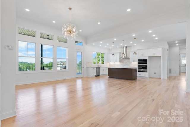 4227 Holly Cir NE, Conover, NC 28613 - unfurnished living room featuring light wood-style floors, baseboards, recessed lighting, and a notable chandelier