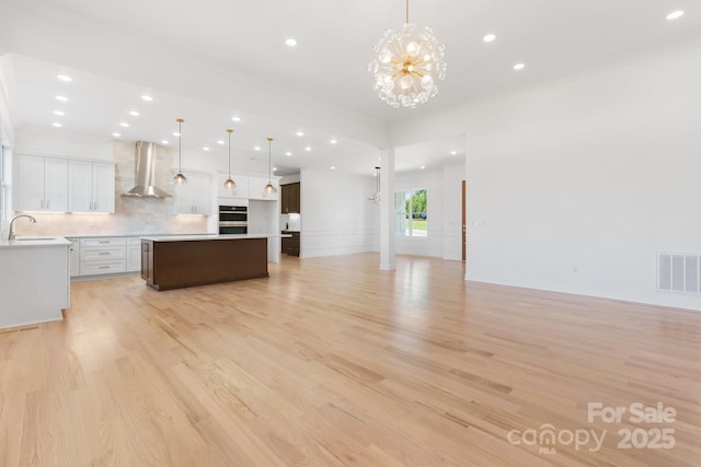 4227 Holly Cir NE, Conover, NC 28613 - unfurnished living room featuring visible vents, a sink, a chandelier, and recessed lighting