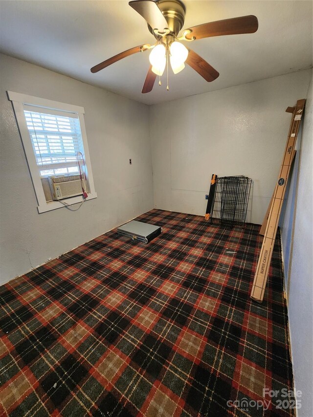 unfurnished bedroom with cooling unit, carpet, and a ceiling fan