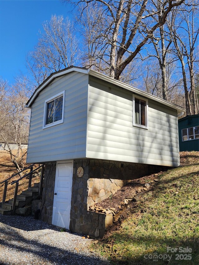 view of side of property featuring stone siding